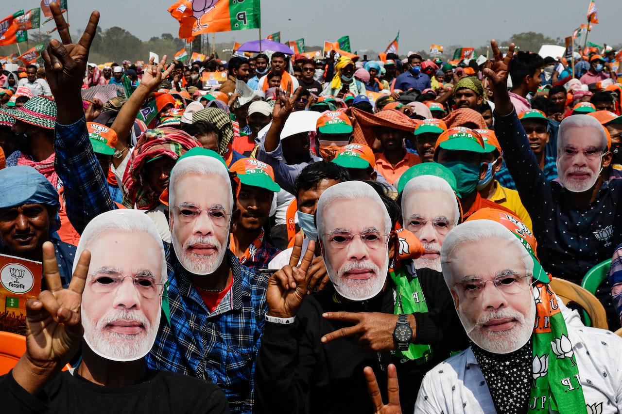Supporters of Prime Minister Narendra Modi's party wear masks depicting his face as they gather for a rally ahead of the West Bengal state elections in Kolkata, India, March 7. Photo: AP