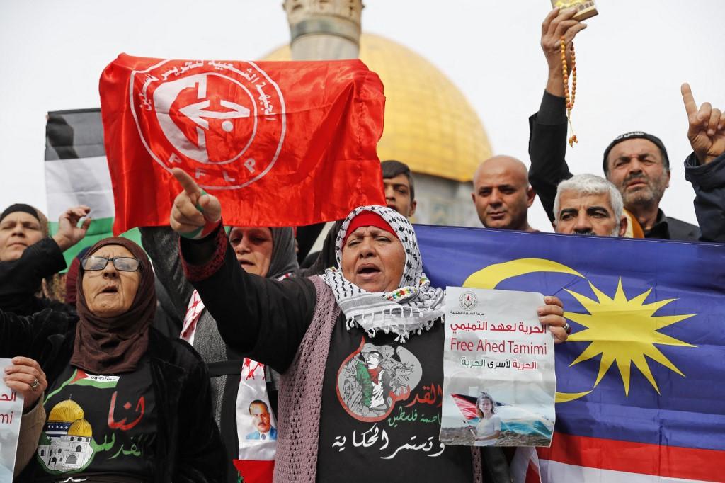 Palestinians in Jerusalem's Old City hold a Malaysian flag in this 2017 protest against Israel. The Malaysian government is a staunch supporter of the Palestinian cause. Photo: AFP