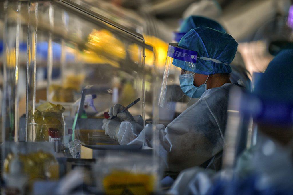 Lab technicians from the Kuching health department in Sarawak test swab samples taken from residents for Covid-19 on March 17. Photo: Bernama