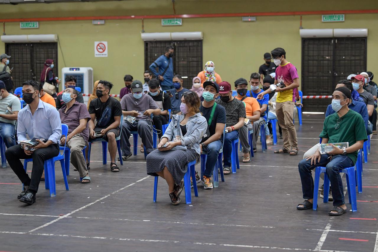 People wait for their turn to be tested for Covid-19 at a community screening programme in Kuala Lumpur. Photo: Bernama