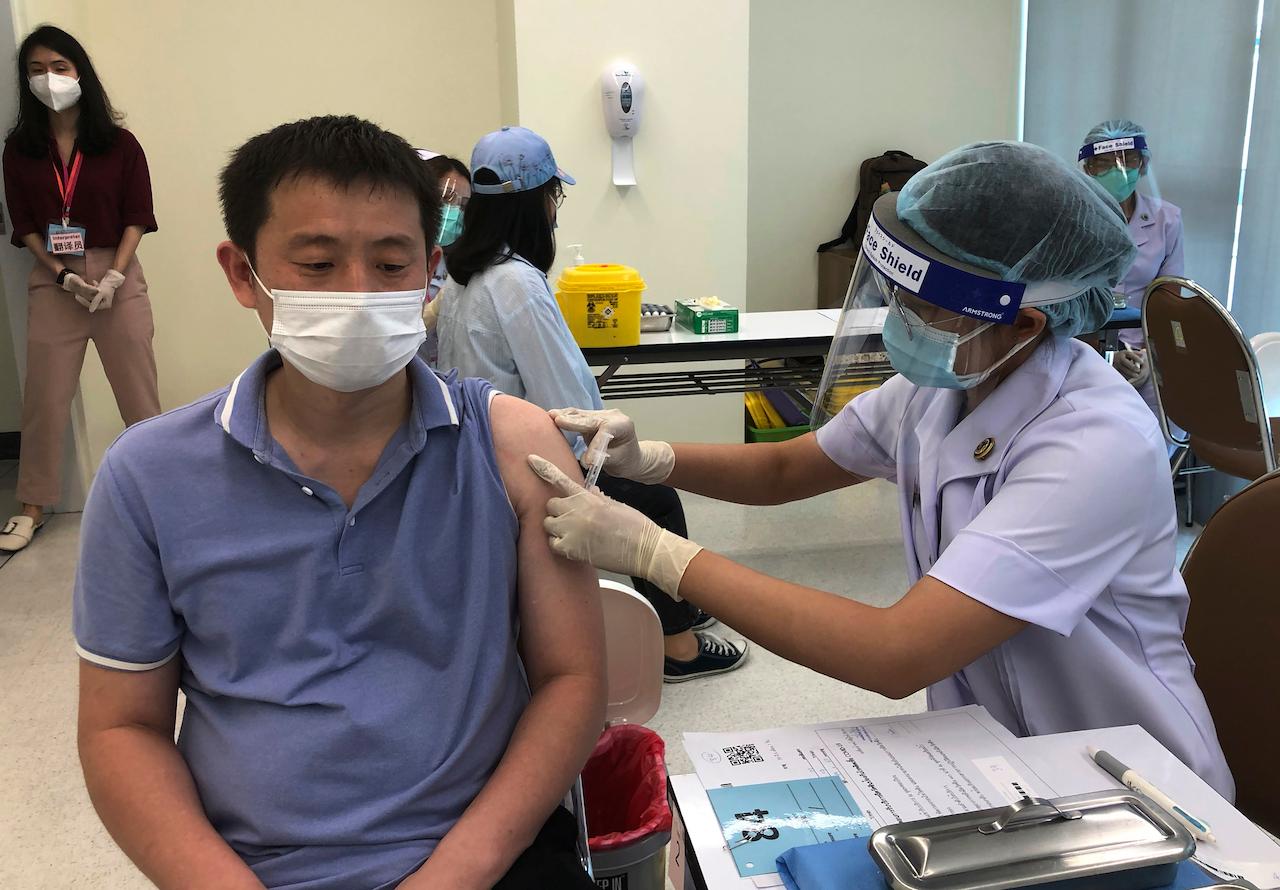 A health worker administers a dose of the Sinovac Covid-19 vaccine to a Chinese businessman in Thailand, at the Bangrak Vaccination & Health Center in Bangkok, Thailand, May 20. China began vaccinating its citizens living in Thailand on Thursday as part of a global campaign to inoculate its nationals living and working abroad. Photo: AP
