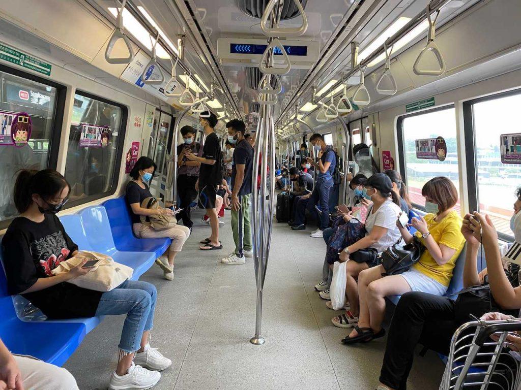 Commuters wear face masks and practise social distancing while onboard a subway in Singapore, May 19. Photo: AP