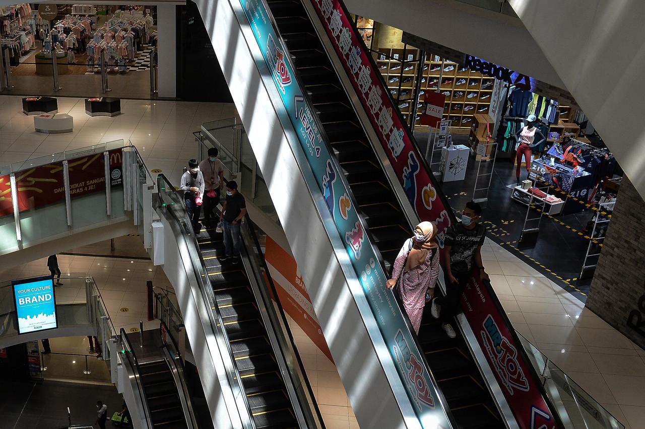 Shoppers take the escalator at a mall in Kuala Lumpur during the movement control order period. Photo: Bernama