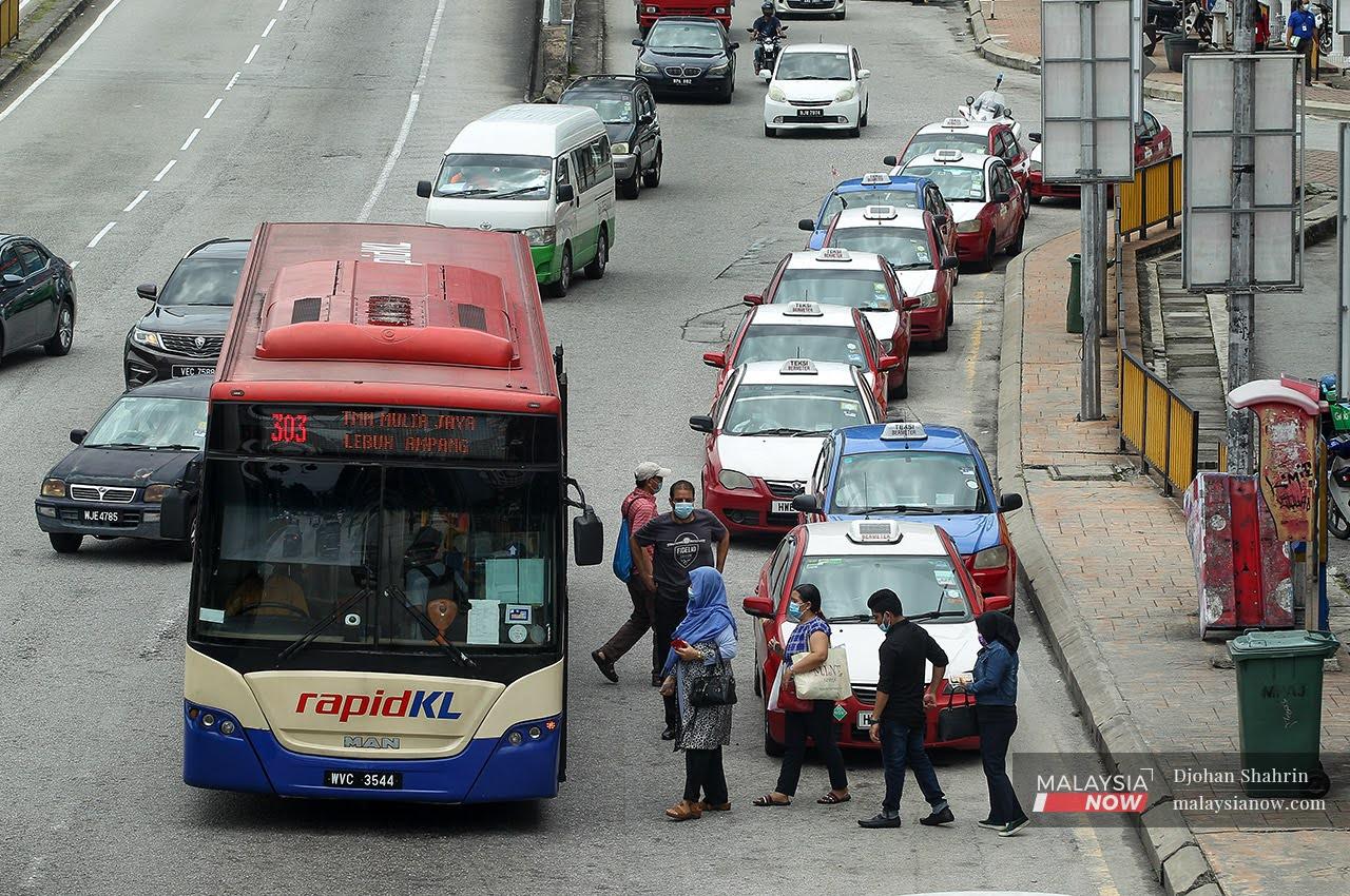Commuters queue to board a bus at Ampang Point in Selangor in this Sept 21, 2020 file photo. Many who rely on public transport to get around say things have become more difficult throughout the pandemic period.