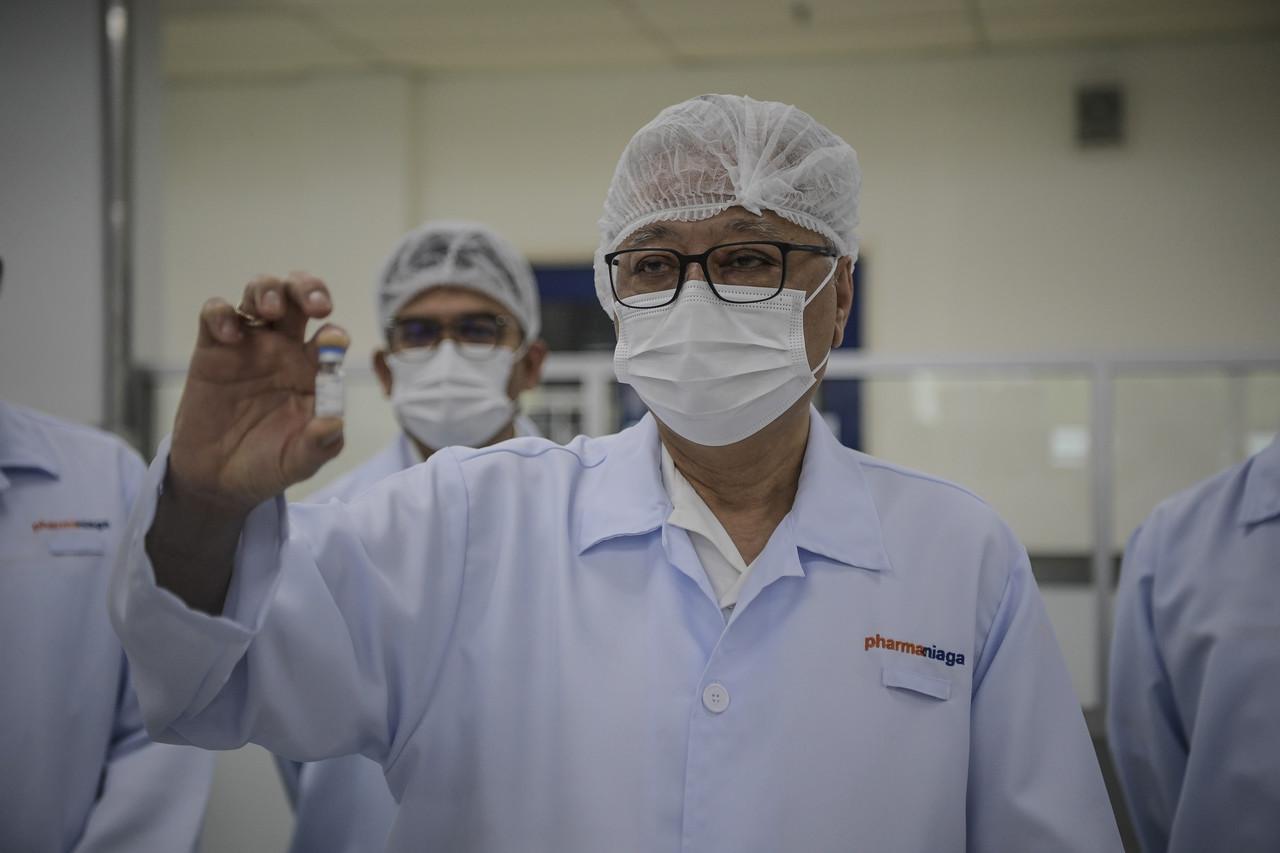 Menteri Kanan (Kluster Keselamatan) Ismail Sabri Yaakob menunjukkan vaksin Covid-19 jenis Sinovac yang siap dibotolkan dan bersedia untuk diedarkan ketika lawatan kerja beliau ke kilang pembotolan vaksin tersebut di Pharmaniaga Lifescience Sdn. Bhd. hari ini. Gambar: Bernama