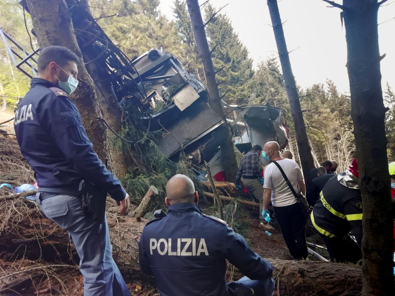 Rescuers work by the wreckage of a cable car after it collapsed near the summit of the Stresa-Mottarone line in the Piedmont region, northern Italy, May 23. Photo: AP