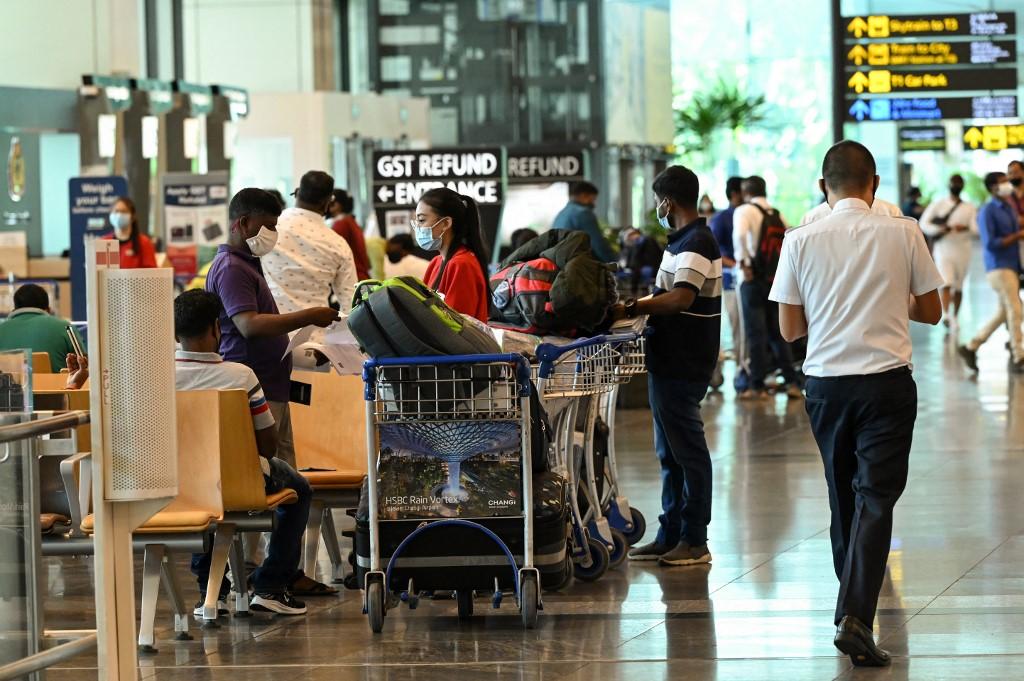 Travellers wait at the departure hall of Changi International Airport in Singapore on March 15. Changi airport was one of three locations where clinical trials for the BreFence Go Covid-19 Breath Test System were held. Photo: AFP
