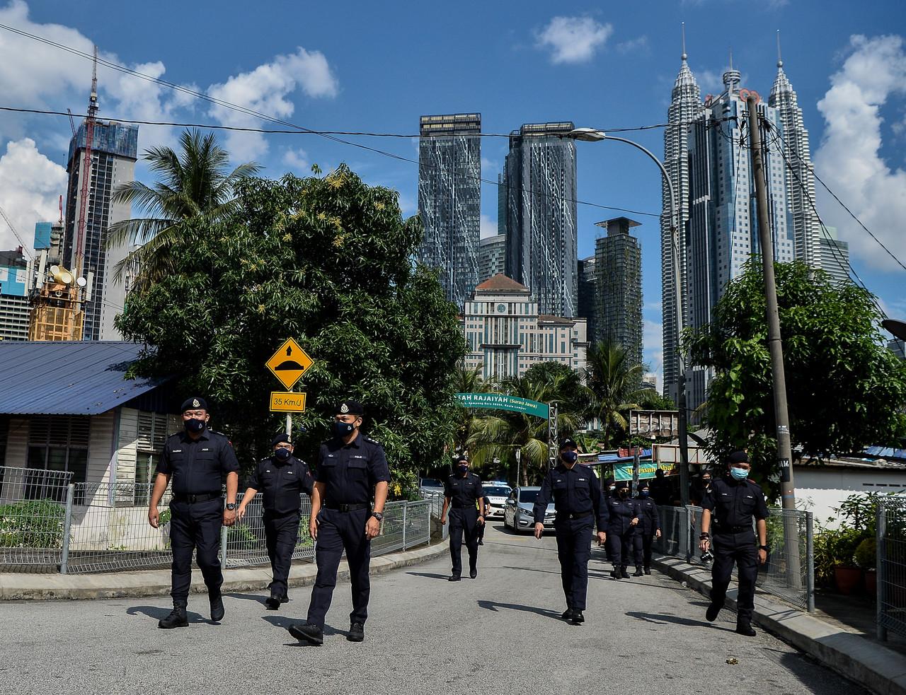 Police officers patrol an area in Kuala Lumpur during the movement control order earlier this month. The government says enforcement of SOPs at the workplace will be stepped up to ensure that members of the public comply with health measures to curb the spread of Covid-19. Photo: Bernama