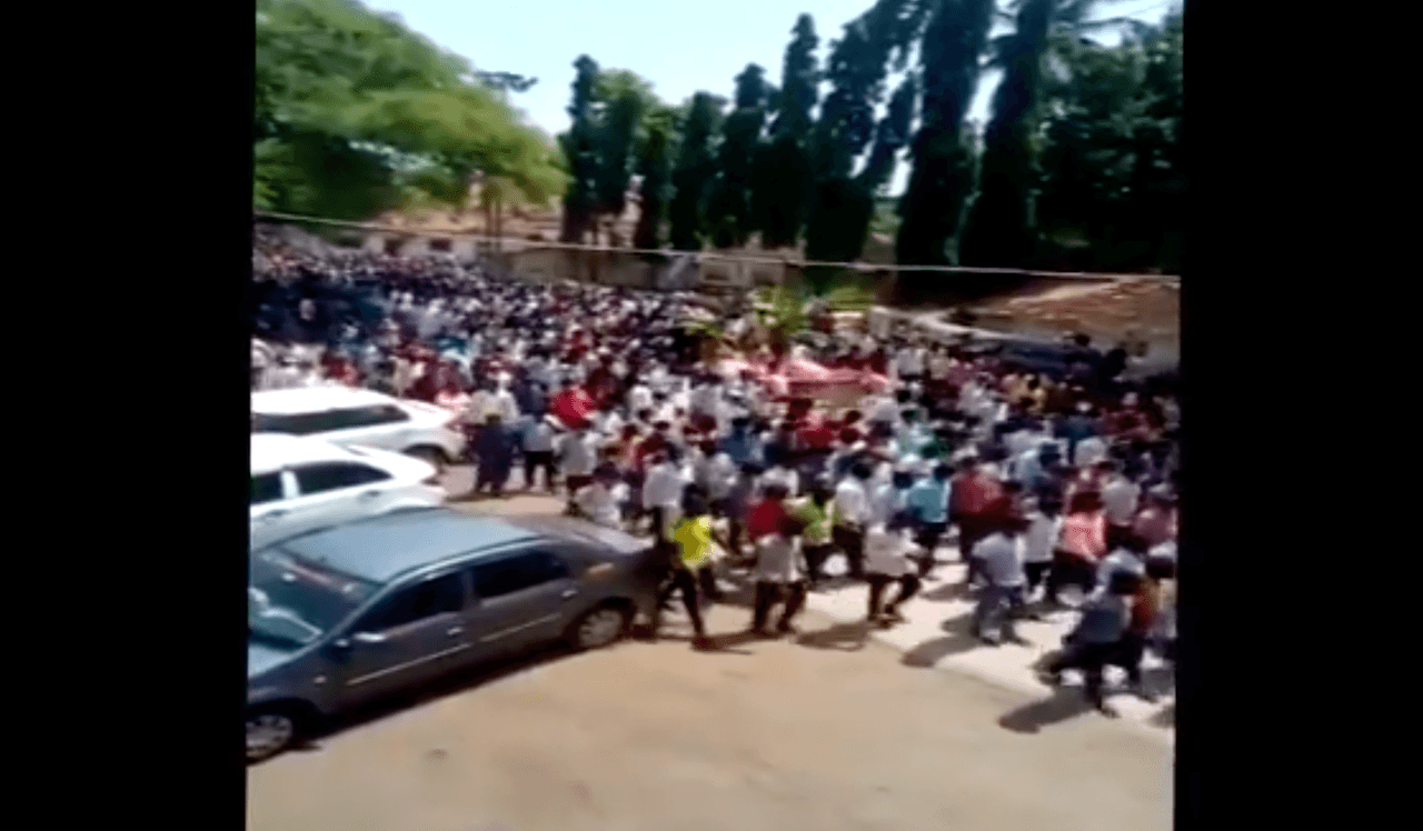 A screenshot of a video showing hundreds of people participating in a funeral procession for a horse, believed to have been divine, in Karnataka, India.