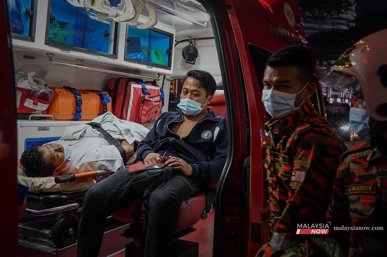 Injured passengers wait in an ambulance after the collision between two LRT trains on the Kelana Jaya line in Kuala Lumpur last night.