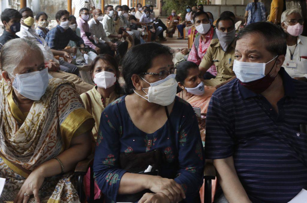 People wait to receive vaccine for Covid-19 outside a vaccination centre in Mumbai, India, May 13. Photo: AP