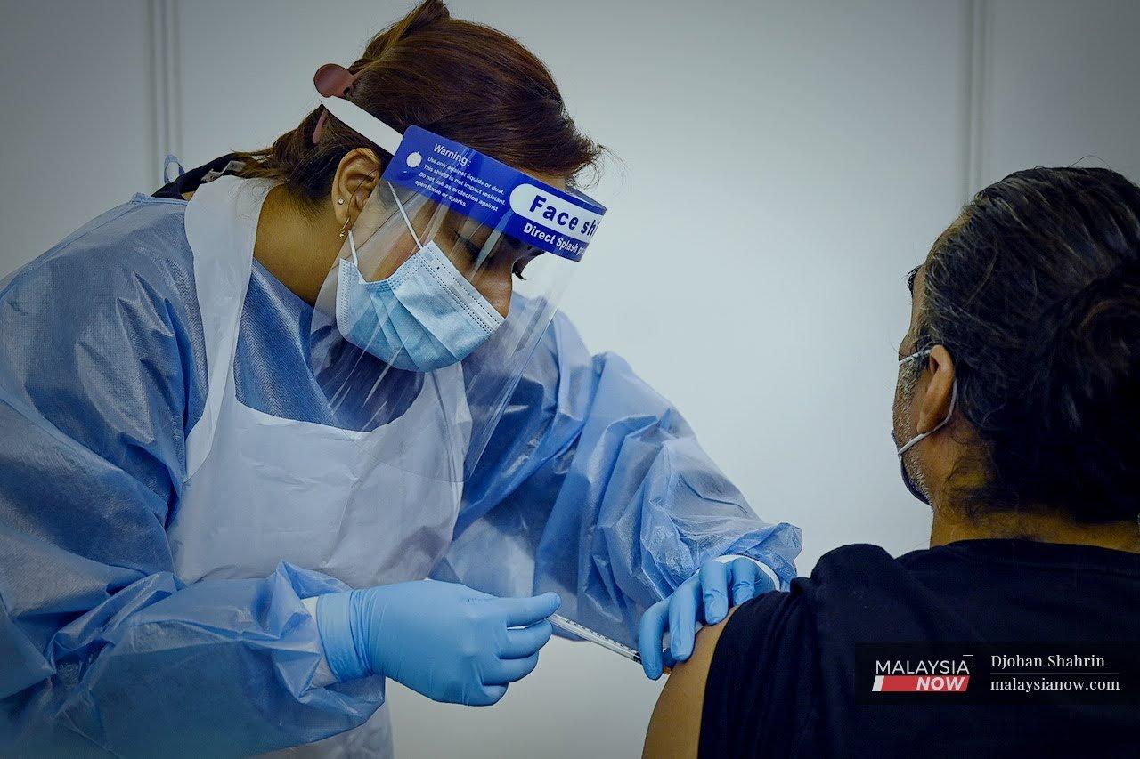 A health worker administers a dose of the AstraZeneca Covid-19 vaccine at the World Trade Centre in Kuala Lumpur on May 5.