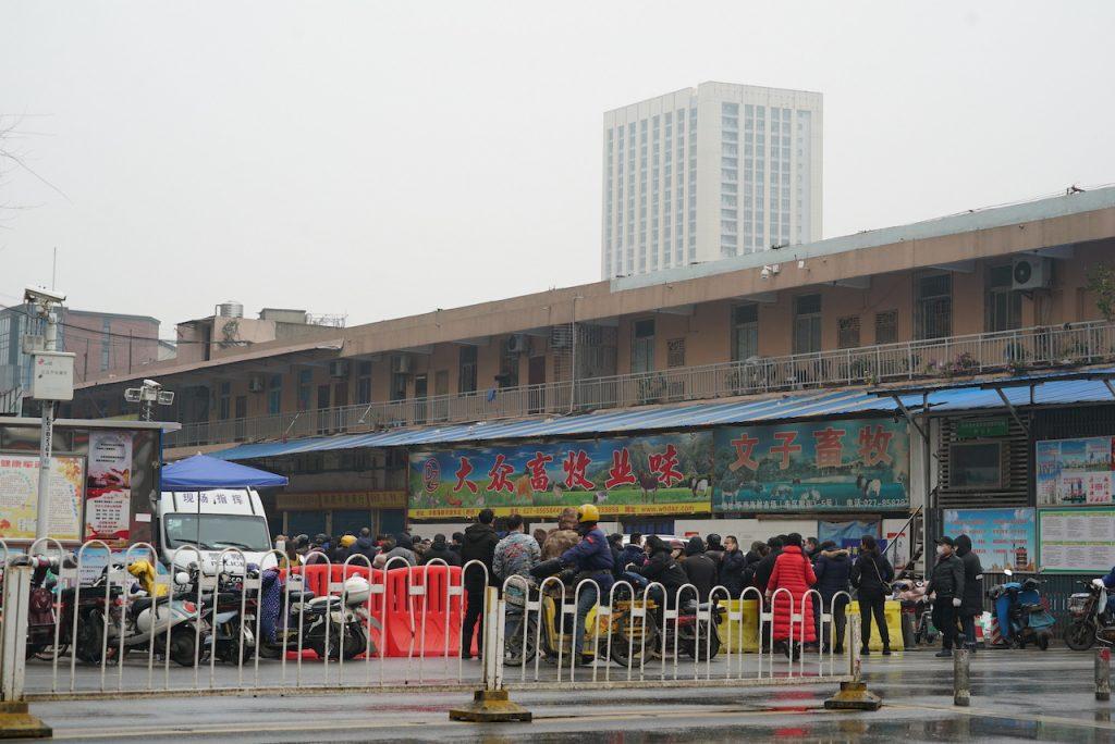 People gather outside the Wuhan Huanan wholesale seafood market where the Covid-19 outbreak was said to have started. Photo: AP