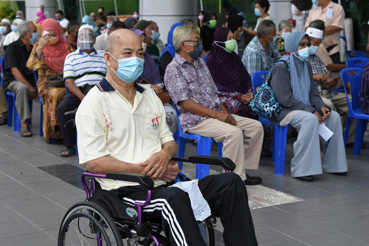 Senior citizens and those from the high-risk group wait to receive their vaccination shots under the second phase of the National Covid-19 Immunisation Programme at the Terengganu Science and Creativity Centre in Kampung Laut. Photo: Bernama