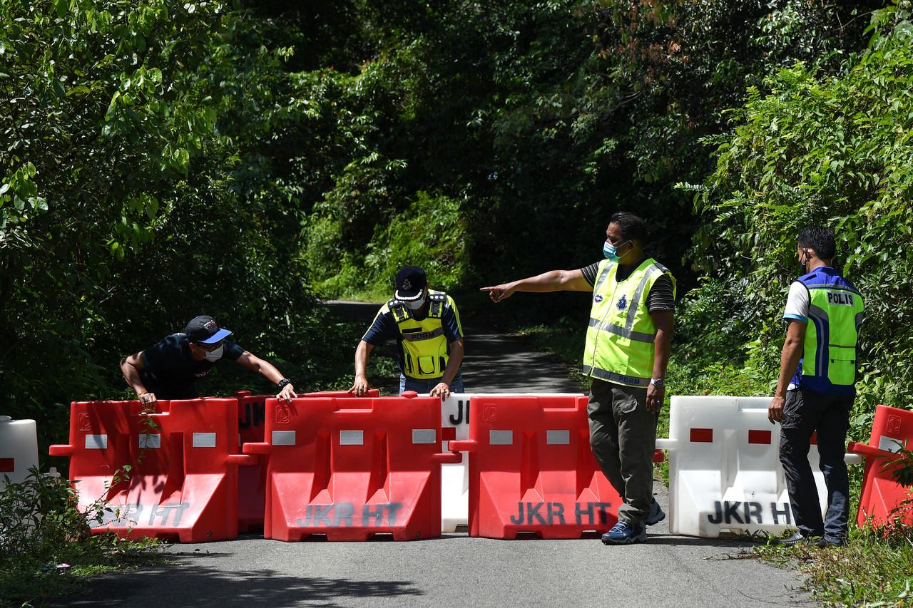 Police set up barriers at Jalan Kampung Buluh heading to Kuala Por at Kuala Berang in Hulu Terengganu, which is under enhanced movement control order until June 11. Photo: Bernama