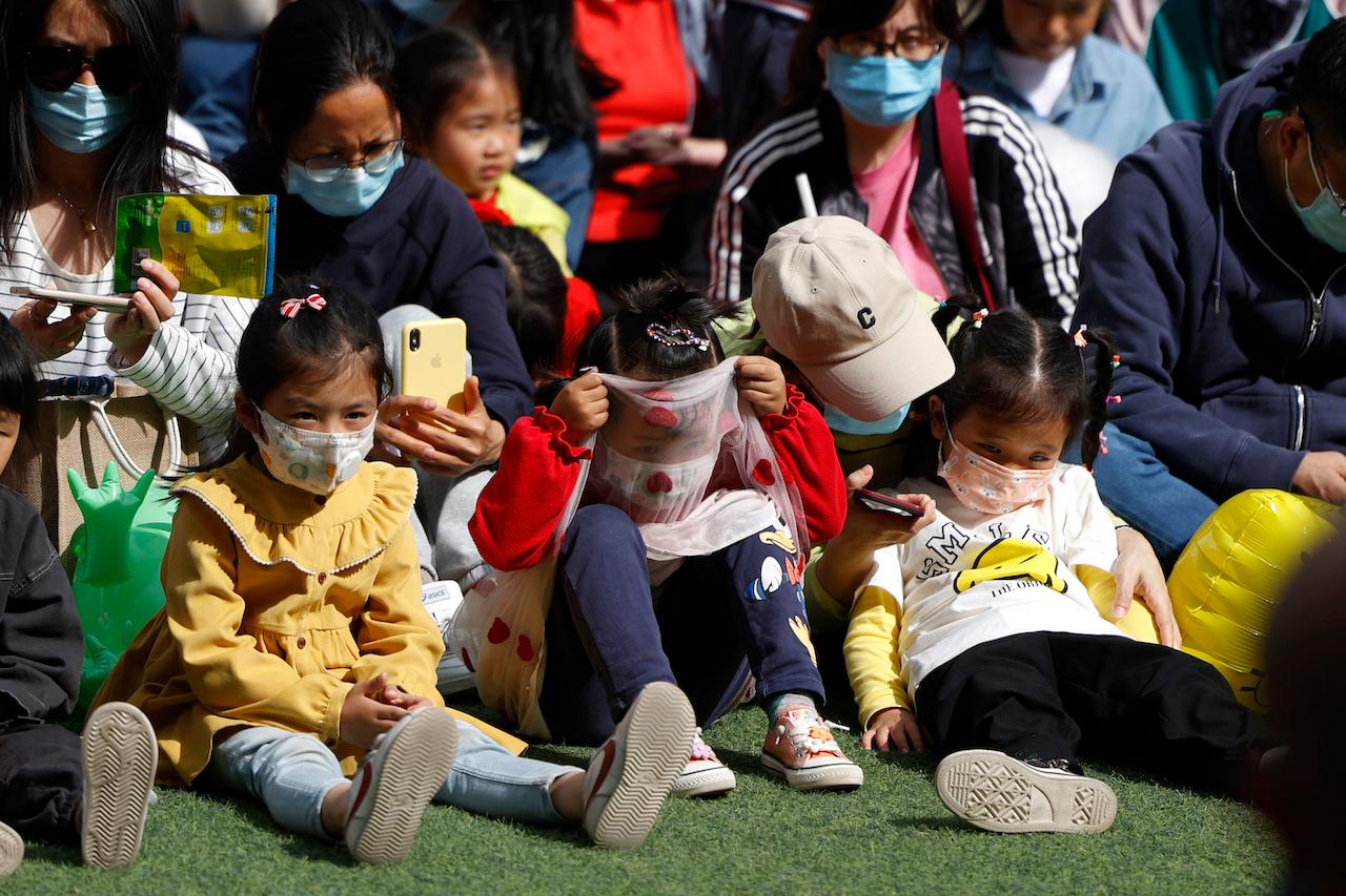 Children gather for a concert during a fair for the May Day holidays at a mall in Beijing, May 4. Photo: AP
