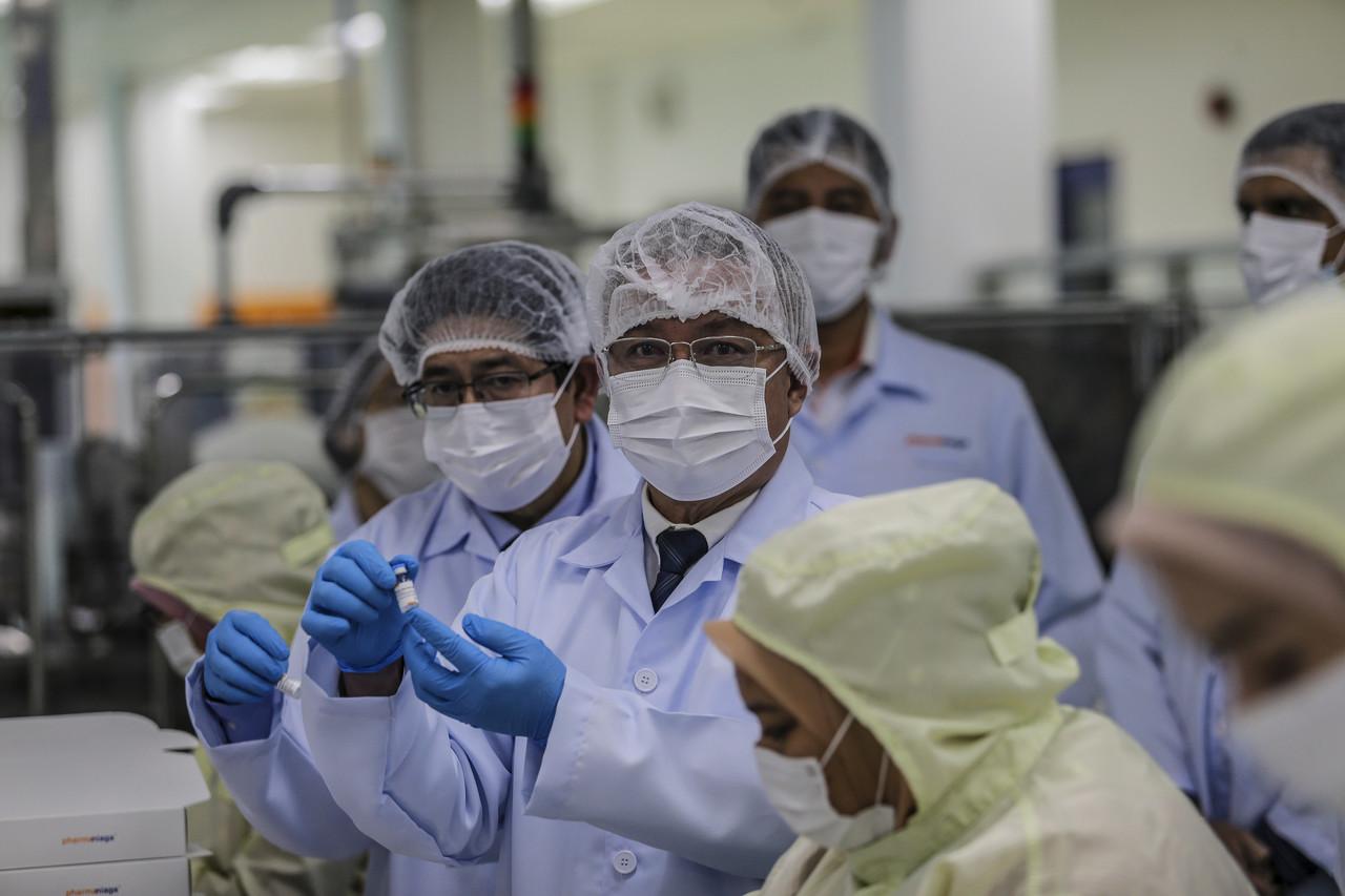 Health Minister Dr Adham Baba (centre) shows a bottle of the Sinovac Covid-19 vaccine during a visit to the Pharmaniaga LifeScience high-tech factory at Taman Perindustrian Puchong Utama, Kuala Lumpur, today. Photo: Bernama