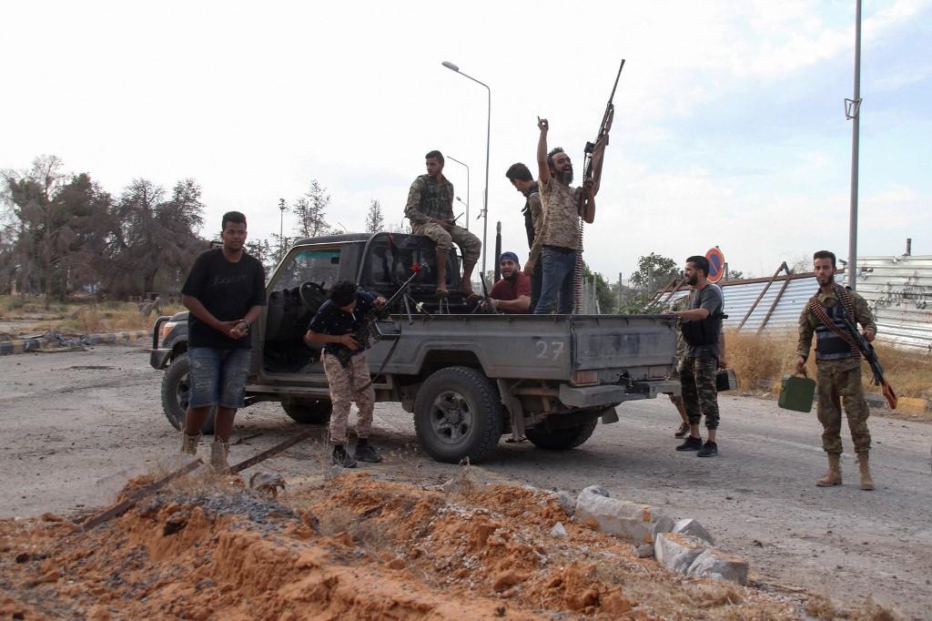 Fighters loyal to the UN-recognised Libyan Government of National Accord cheer after reseizing the capital Tripoli International Airport from rival forces loyal to strongman Khalifa Haftar, on June 3, 2020. Photo: AFP