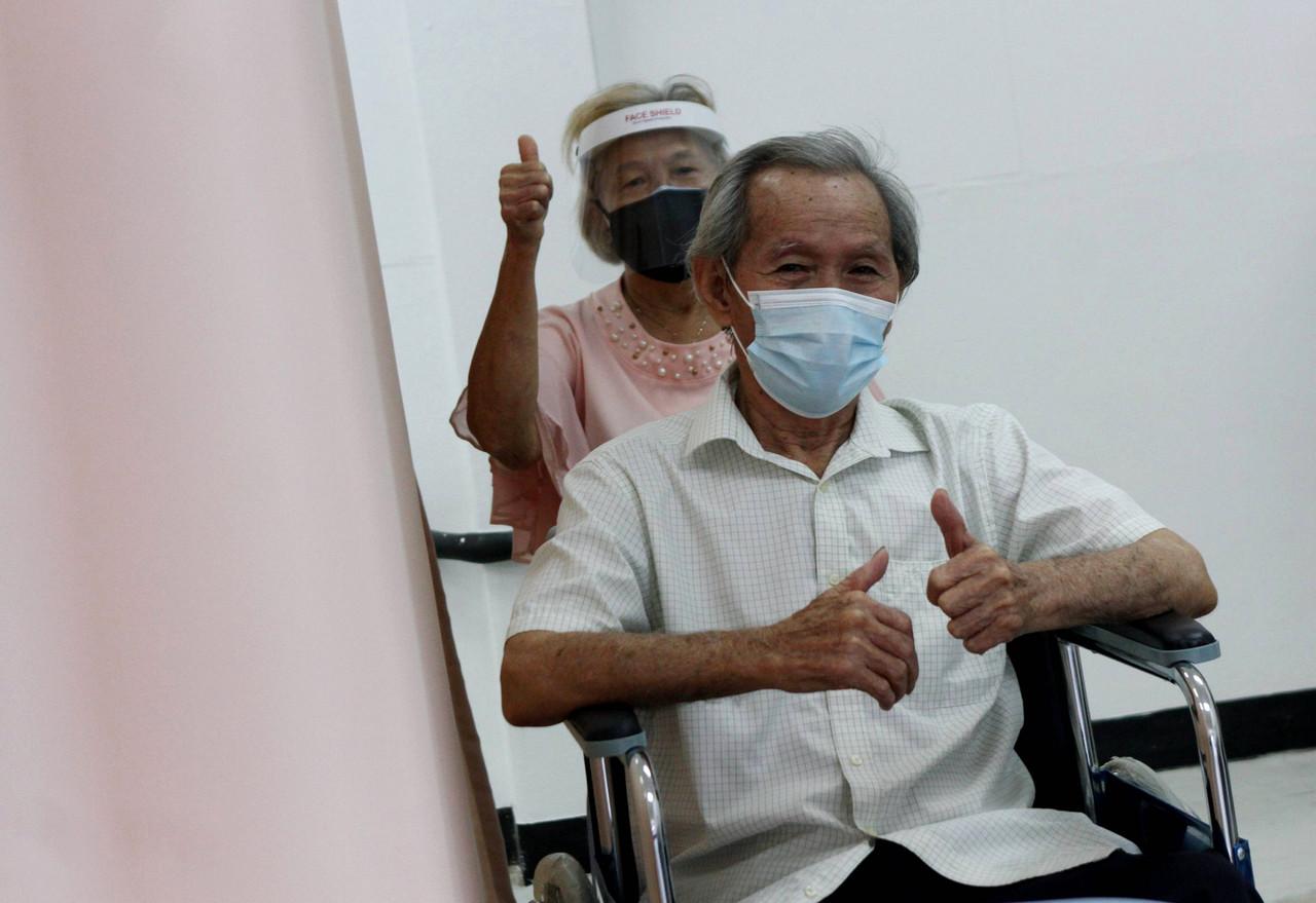A senior citizen gives a thumbs up after receiving a dose of the Sinovac Covid-19 vaccine at the Perak Community Specialist Hospital in Ipoh. Photo: Bernama