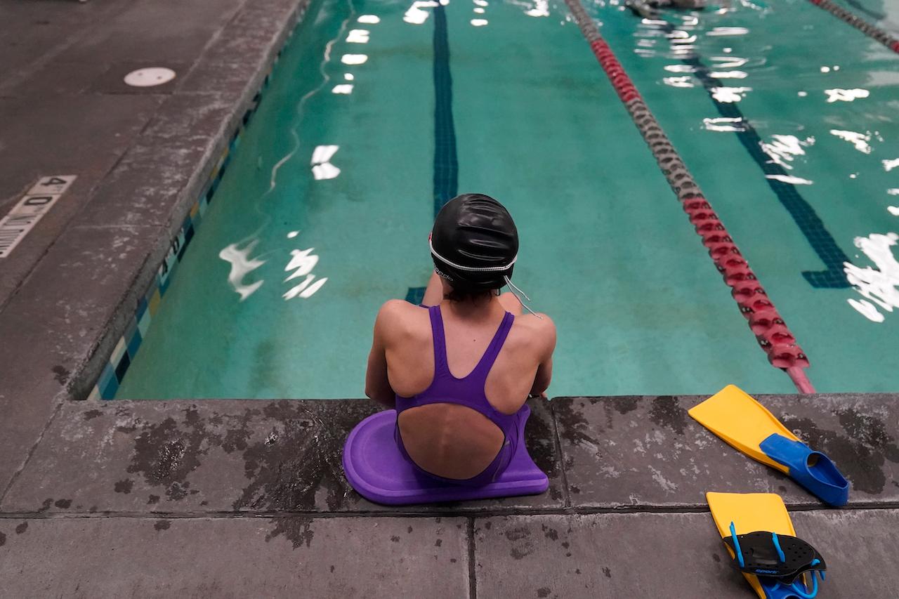 A 12-year-old transgender girl sits by the pool in a school in Utah, US, in this Feb 22 file photo. Photo: AP