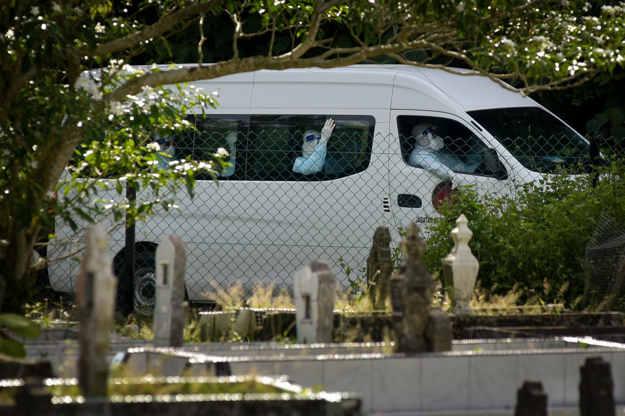 A van carrying the body of a Covid-19 victim for burial arrives at a special Covid-19 cemetery at Kampung Sungai Lada in Labuan. Photo: Bernama