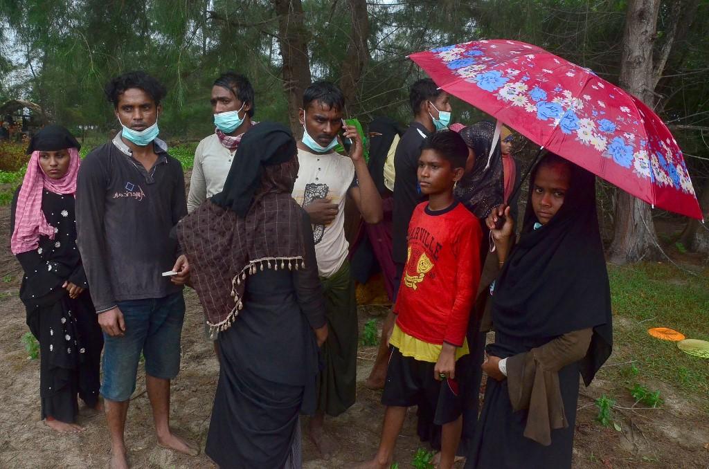 A group of Rohingya refugees gather on a beach after arriving at Pulau Idaman, a small island off the coast of East Aceh in northern Sumatra on June 4. Photo: AFP