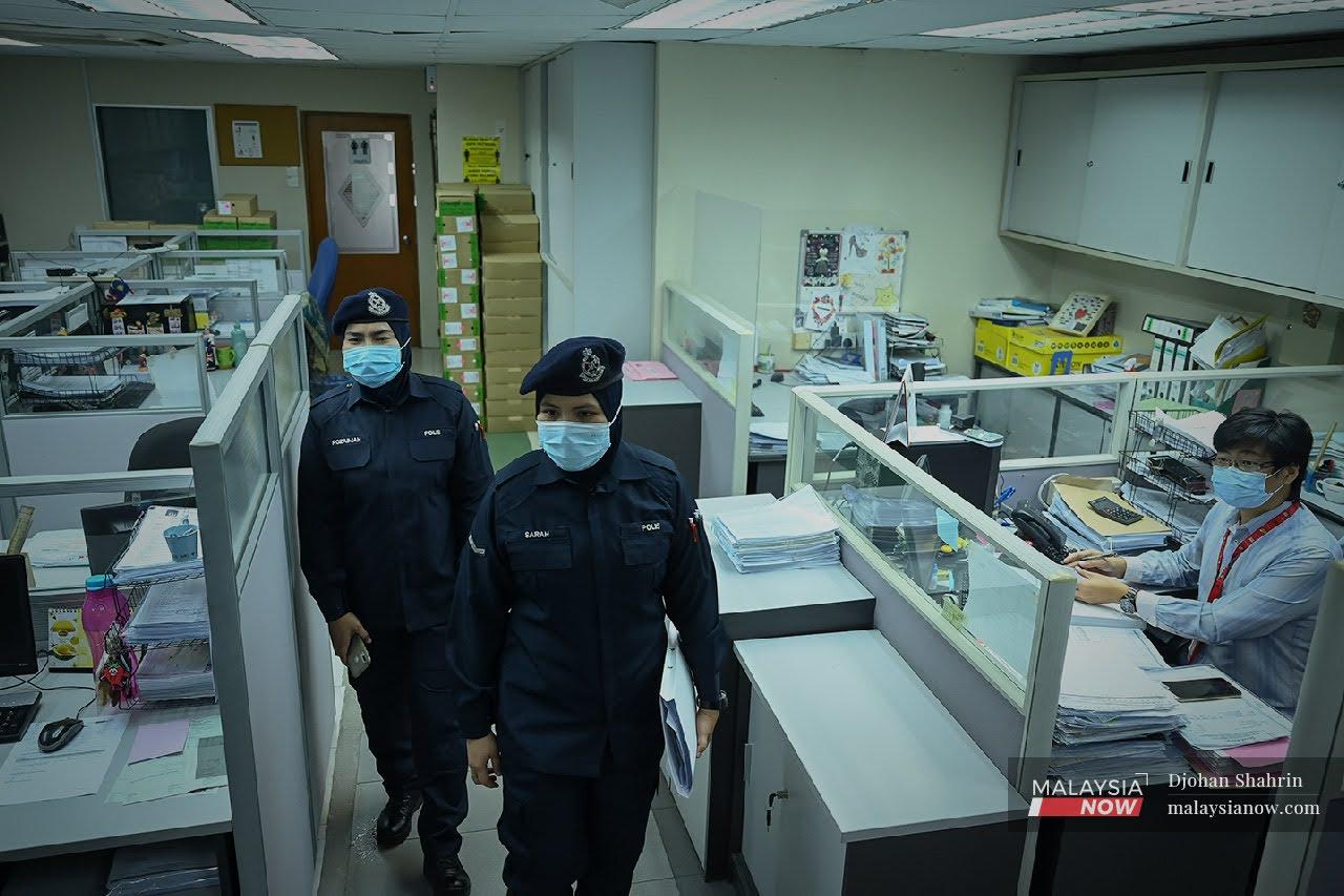 Police check SOP compliance at an office in Petaling Jaya on June 1, the first day of the two-week nationwide lockdown.
