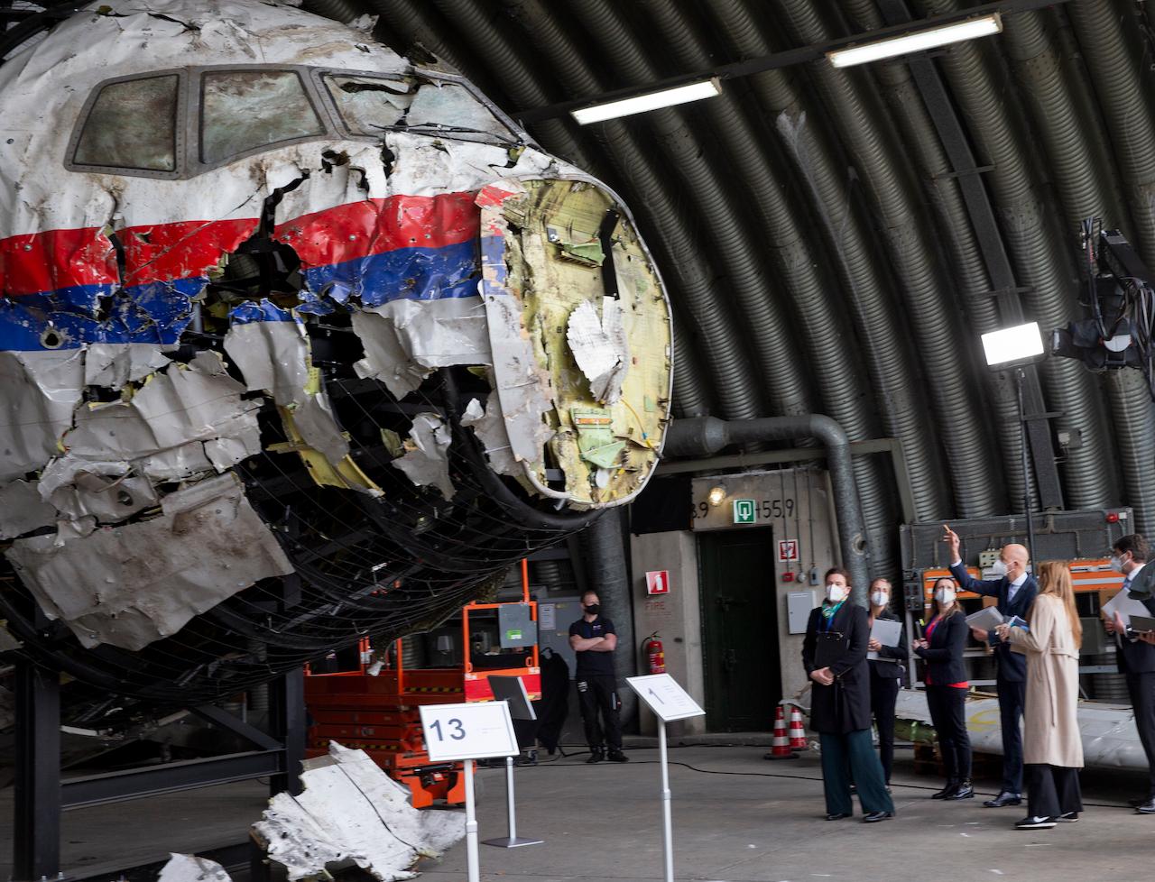 Presiding judge Hendrik Steenhuis (right) points as he and other trial judges and lawyers view the reconstructed wreckage of Malaysia Airlines flight MH17, at the Gilze-Rijen military airbase, southern Netherlands, May 26. Photo: AP