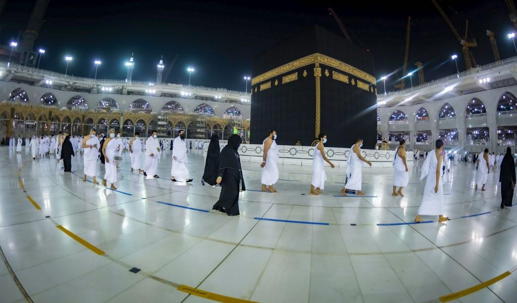 Pilgrims observe social distancing as they circle the kaaba, the cubic building at the Grand Mosque, in the city of Mecca, Saudi Arabia, in this file photo taken Oct 4, 2020. Photo: AFP