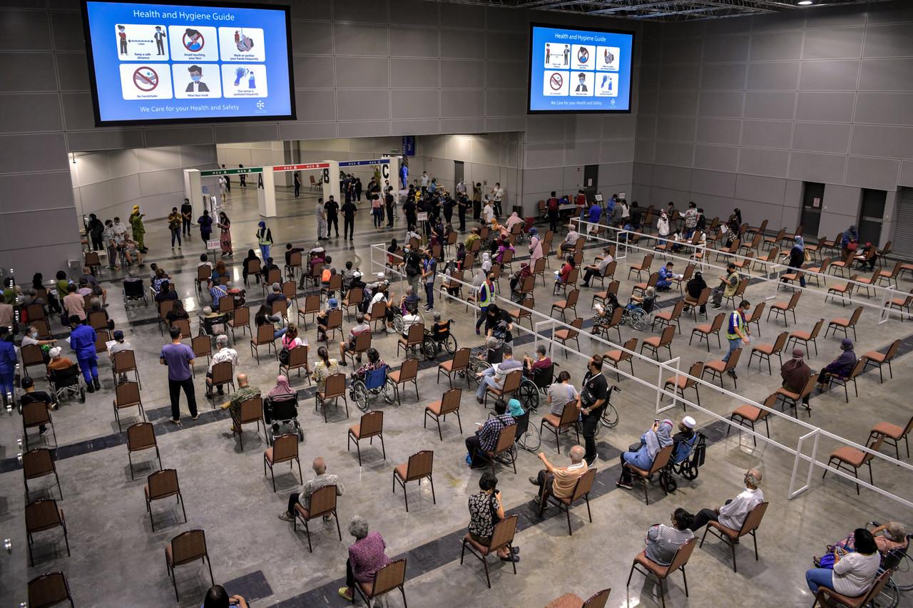 Senior citizens wait for their turn to be vaccinated against Covid-19 at the Kuala Lumpur Convention Centre. Photo: Bernama