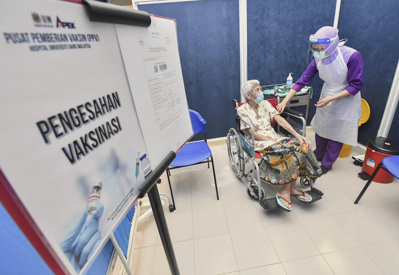 A nurse reassures a senior citizen before administering a dose of Covid-19 vaccine at the special vaccination centre at Hospital Universiti Sains Malaysia in Kubang Kerian, Kota Bharu. Photo: Bernama