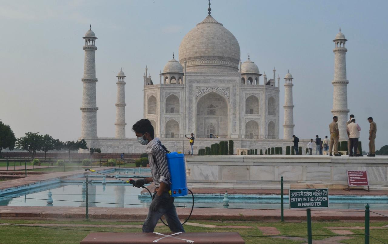 A man disinfects the premises of the Taj Mahal monument that was reopened after being closed for more than six months due to the coronavirus pandemic in Agra, India, Sept 21, 2020. Photo: AP