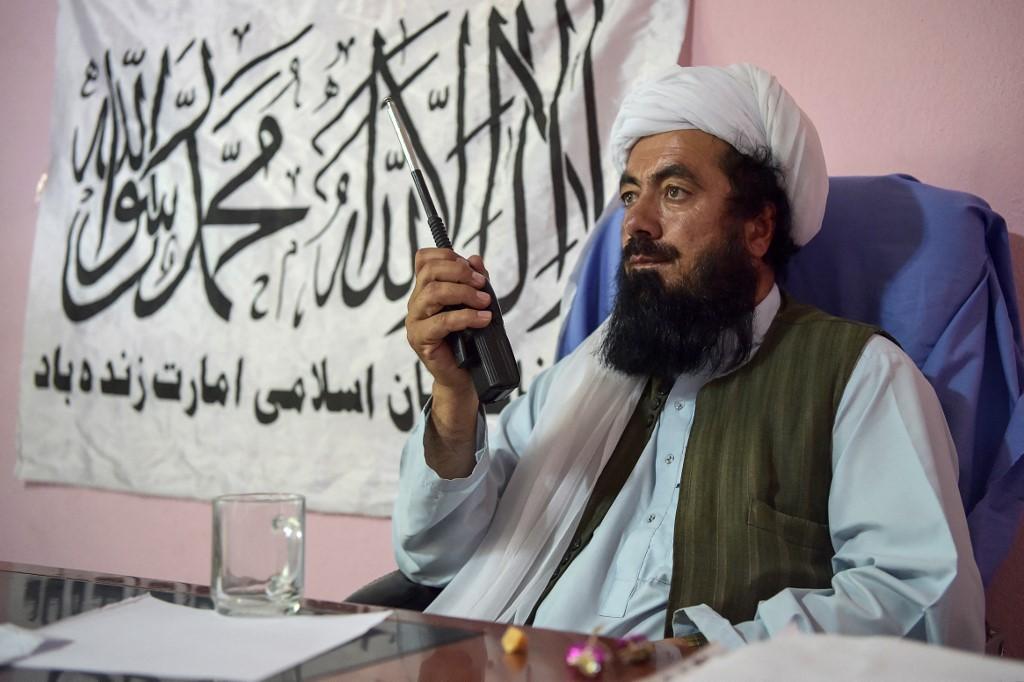 Mullah Misbah, Taliban commander and director of the public health for Ghazni on the Taliban-controlled side, talks on a handheld transceiver ahead of an interview with AFP at a hospital in the Andar district of Ghazni province on June 3. Photo: AFP