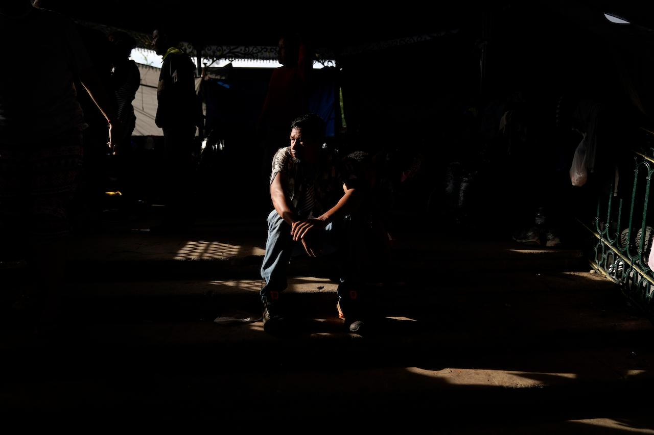 A man from Honduras sits at a makeshift camp for migrants in Reynosa, Mexico, just blocks from the US-Mexico border, May 14. Reynosa is a key crossing point for migrants attempting to reach the US. Photo: AP
