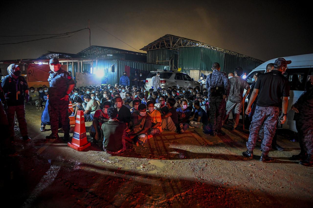 The migrant workers rounded up by the immigration department at a construction site in Dengkil early this morning. Photo: Bernama