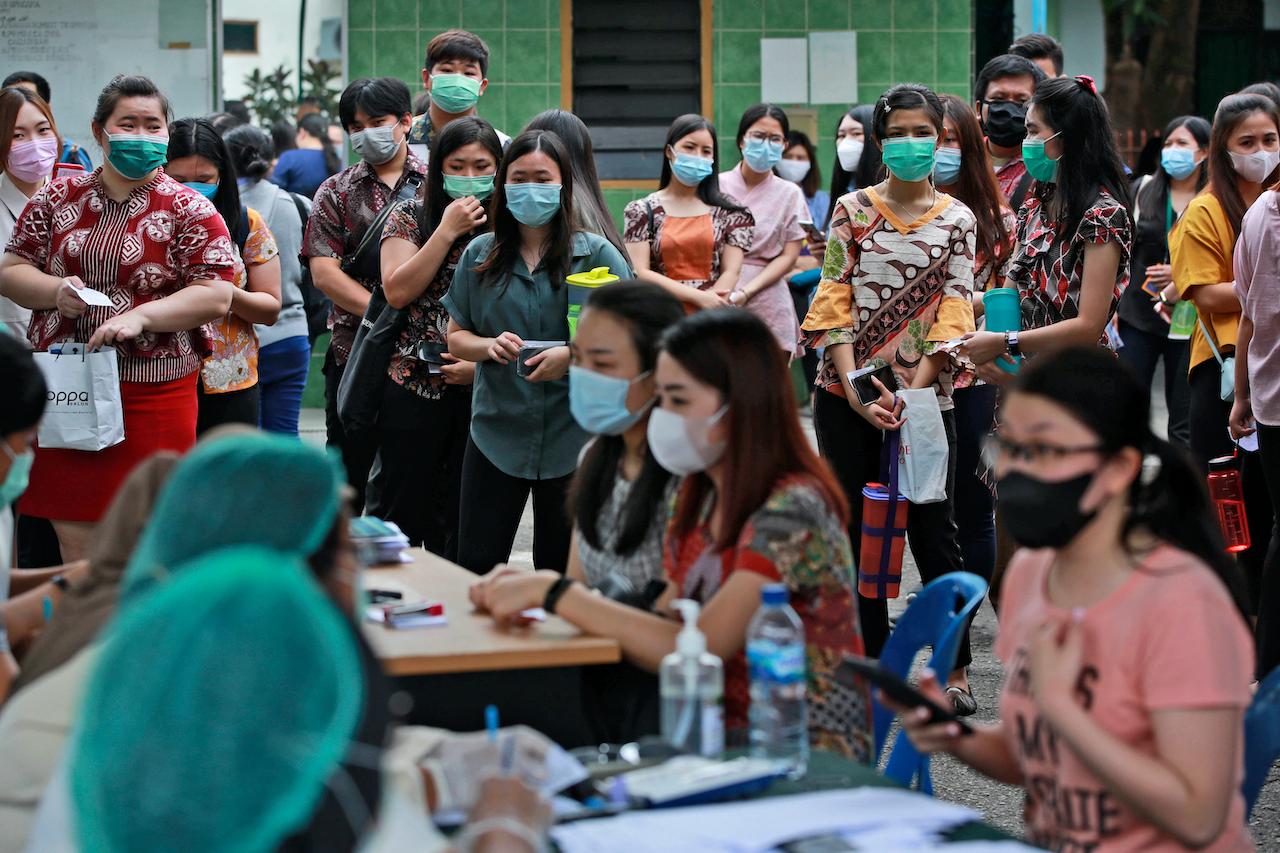 People line up as they wait for their turn to get a shot of the Sinovac Covid-19 vaccine during a mass vaccination at Putri Hijau Military Hospital in Medan, North Sumatra, Indonesia, June 18. Photo: AP