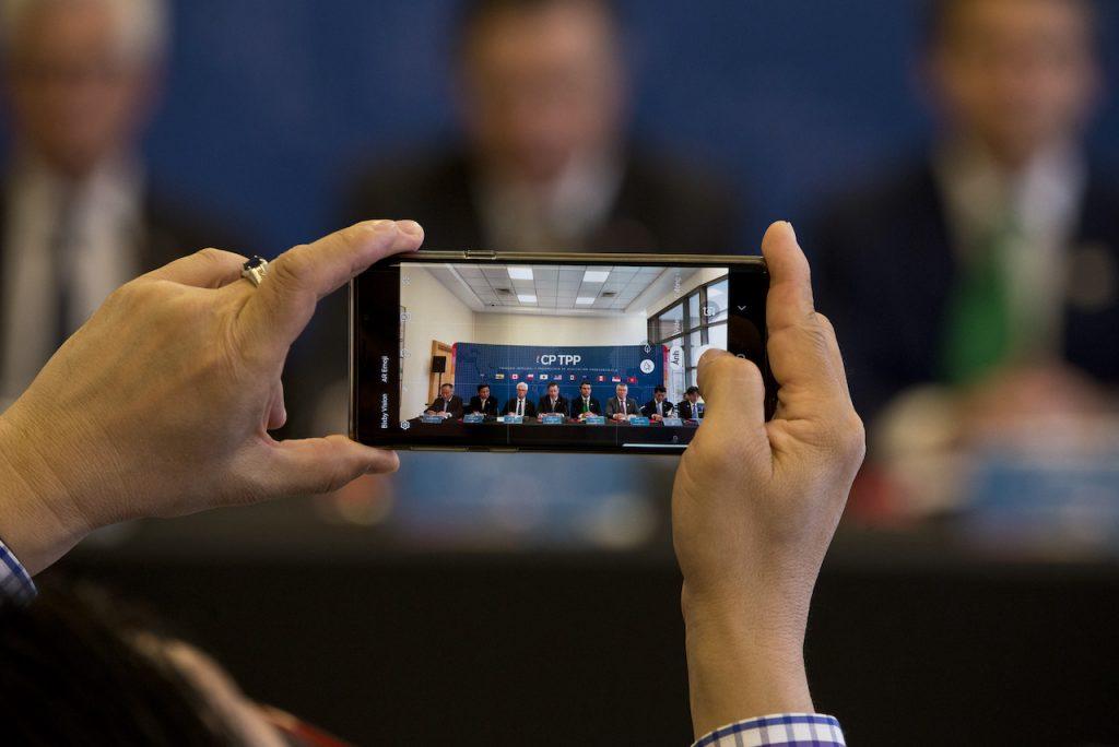 A man takes a photo with his mobile phone during a meeting of the Comprehensive and Progressive Agreement for Trans-Pacific Partnership in Santiago, Chile, May 16, 2019. Photo: AP