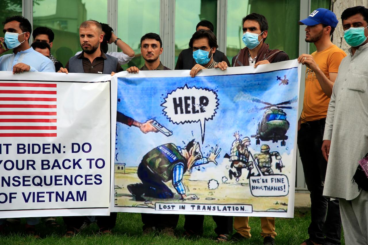 In this April 30 file photo, former Afghan interpreters hold banners during a protest against the US government and Nato in Kabul, Afghanistan. Photo: AP