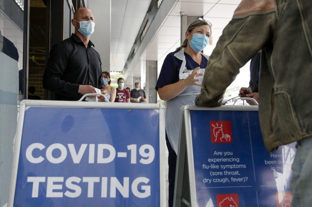 Staff question people as they wait in line at a Covid-19 testing station on the northern beaches in Sydney, Australia, in this Dec 21, 2020 file photo. Sydney is battling to contain an outbreak of the highly infectious Delta variant, with officials reporting 17 new cases on Friday, taking the cluster to 65 cases. Photo: AP