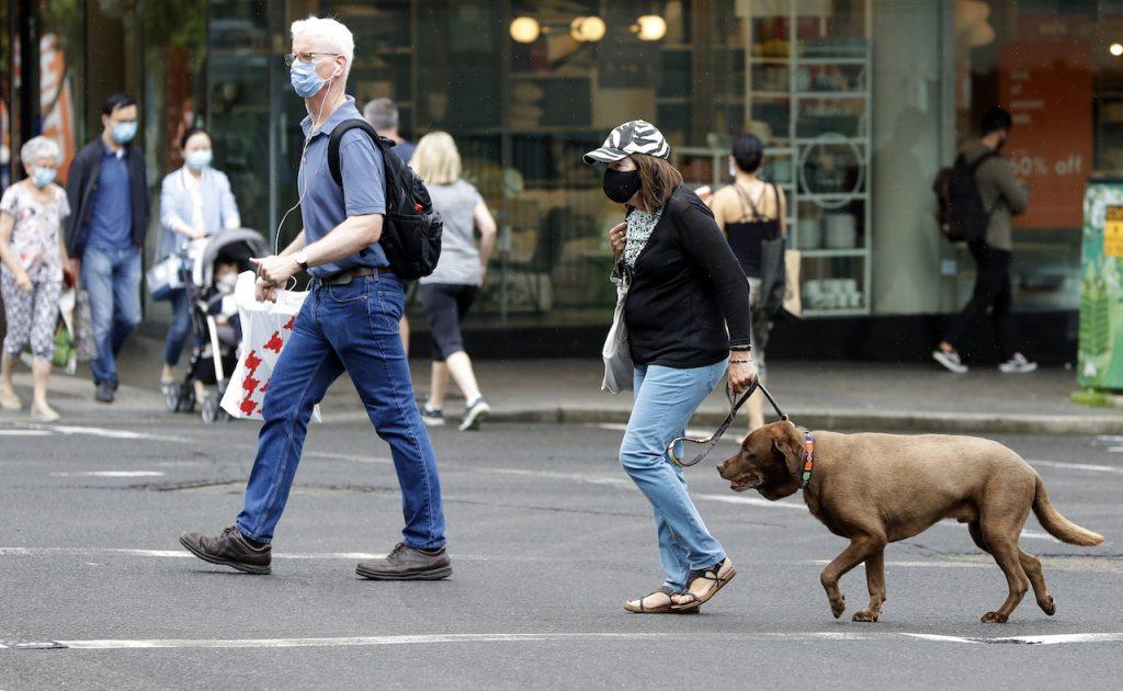 Shoppers wear masks as they walk around a shopping precinct in Sydney, Australia, Jan 3. Australia has been among the world's most successful countries in containing Covid-19, with just over 30,000 cases and 910 deaths in a population of about 25 million. Photo: AP