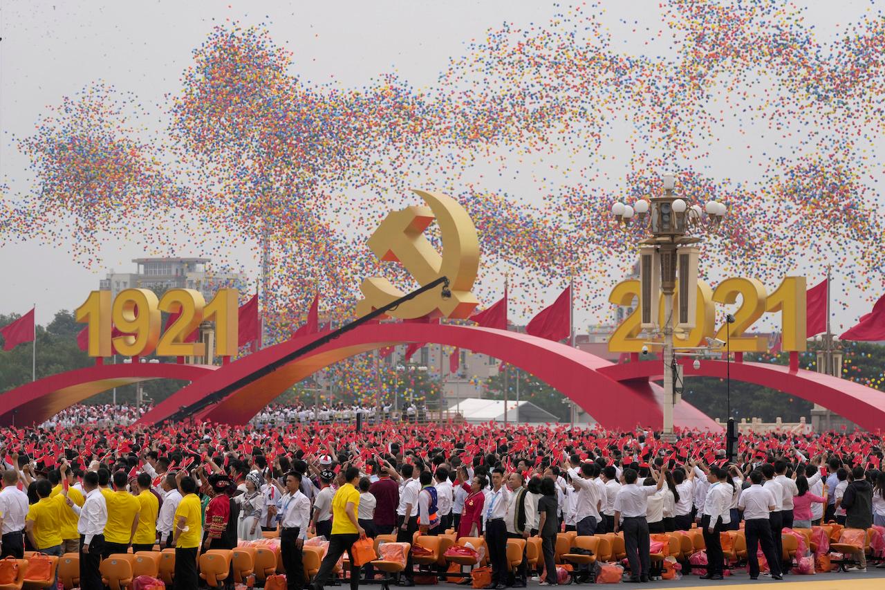 Balloons float over attendees waving Chinese flags during a ceremony at Tiananmen Square to mark the 100th anniversary of the founding of the ruling Chinese Communist Party in Beijing, July 1. Photo: AP