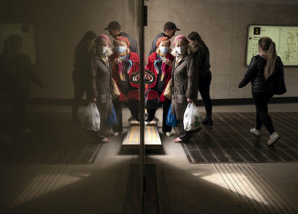In this file photo dated April 19, people, some of them wearing face masks to protect against coronavirus, are reflected in a marble wall of an underpass as they walk in Moscow, Russia. Russia is battling a surging outbreak driven by the highly infectious Delta variant. Photo: AP
