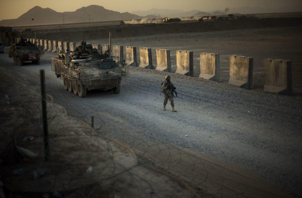 In this Aug 8, 2009, file photo, US soldiers from the 5th Striker Brigades walk next to armoured vehicles as they arrive at their base on the outskirts of Spin Boldak, about 100km southeast of Kandahar, Afghanistan. Photo: AP