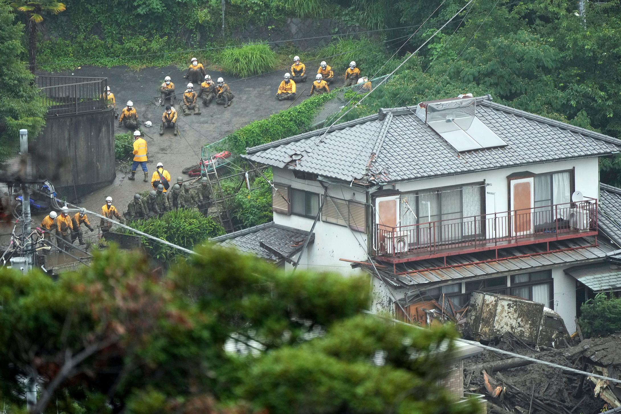 Houses are damaged by a mudslide following heavy rain at the Izusan district in Atami, Shizuoka prefecture, west of Tokyo, July 4. Photo: AP