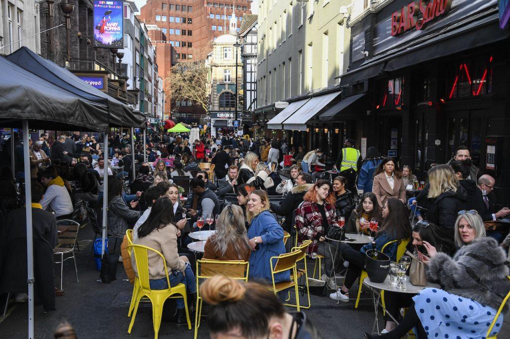 People sit outside cafes and pubs in Soho, central London, in this April 12 file photo. British Prime Minister Boris Johnson says England will move away from legal restrictions 'and allow people to make their own informed decisions'. Photo: AP