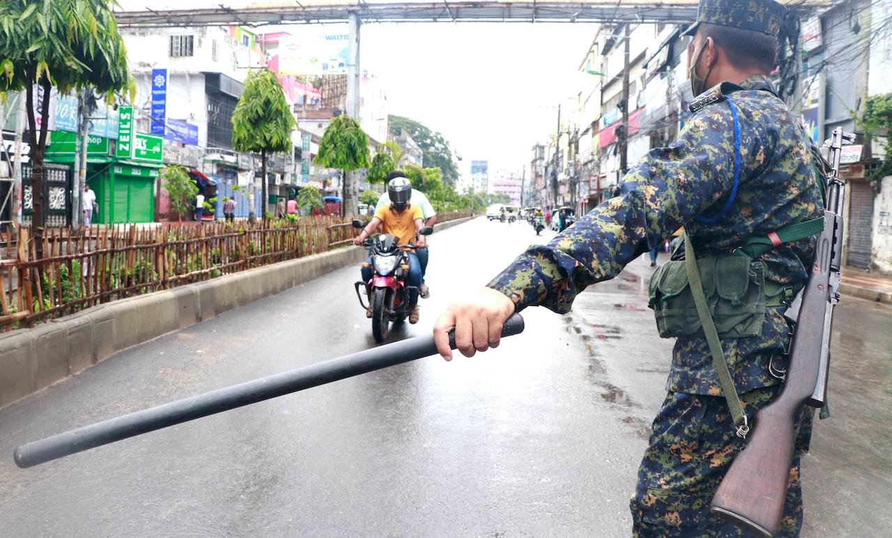 A policeman stops commuters in Rajshahi, 254km north of the capital, Dhaka, Bangladesh, June 16. Photo: AP