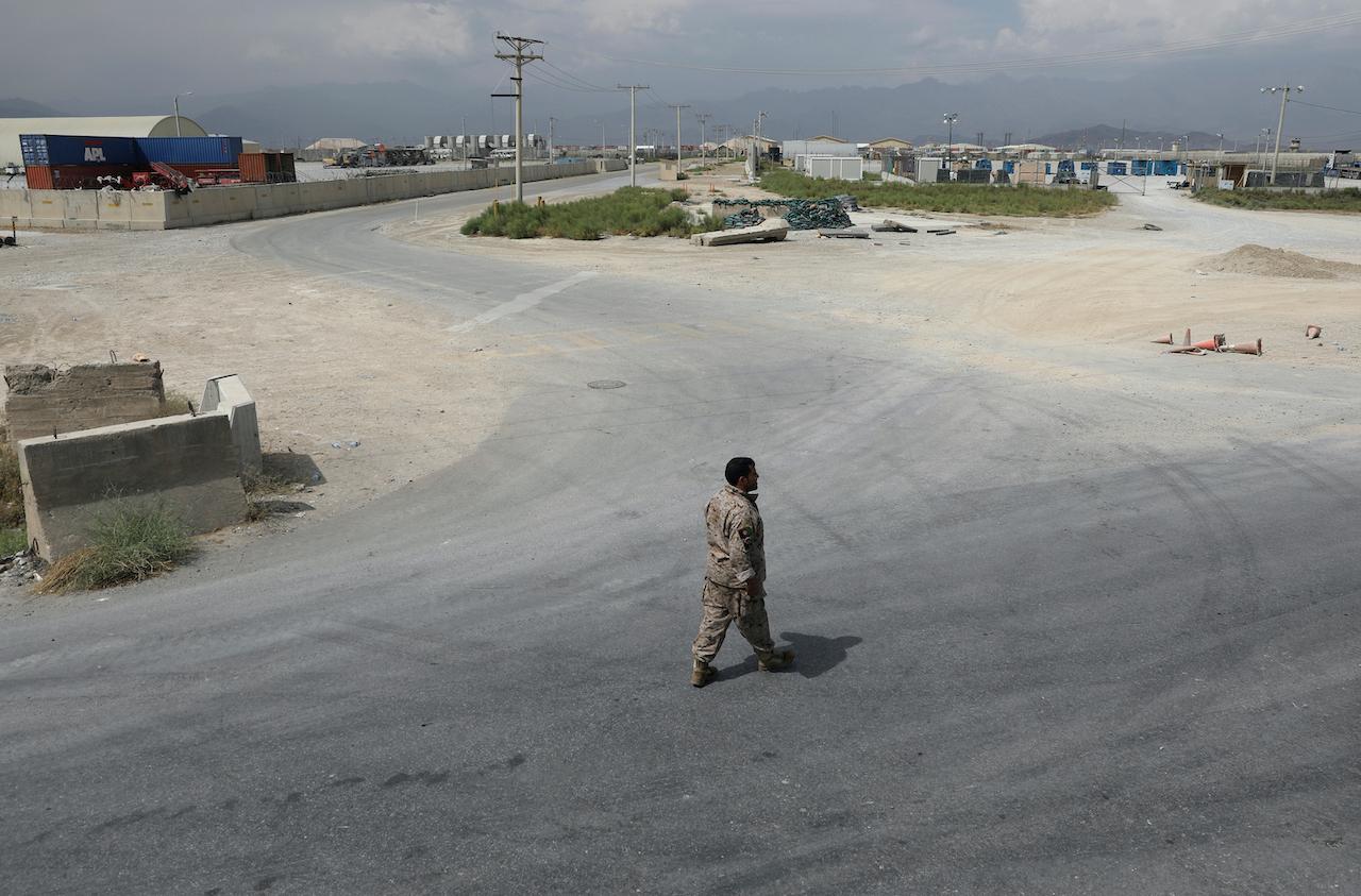 A member of the Afghan security forces walks in the sprawling Bagram air base after the American military departed, in Parwan province north of Kabul, Afghanistan, July 5. Photo: AP