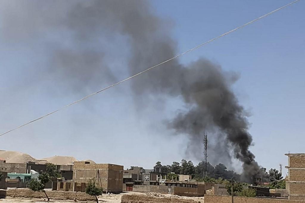 A smoke plume rises from houses amid an ongoing fight between Afghan security forces and Taliban fighters in the western city of Qala-i- Naw, the capital of Badghis province, July 7. Photo: AFP