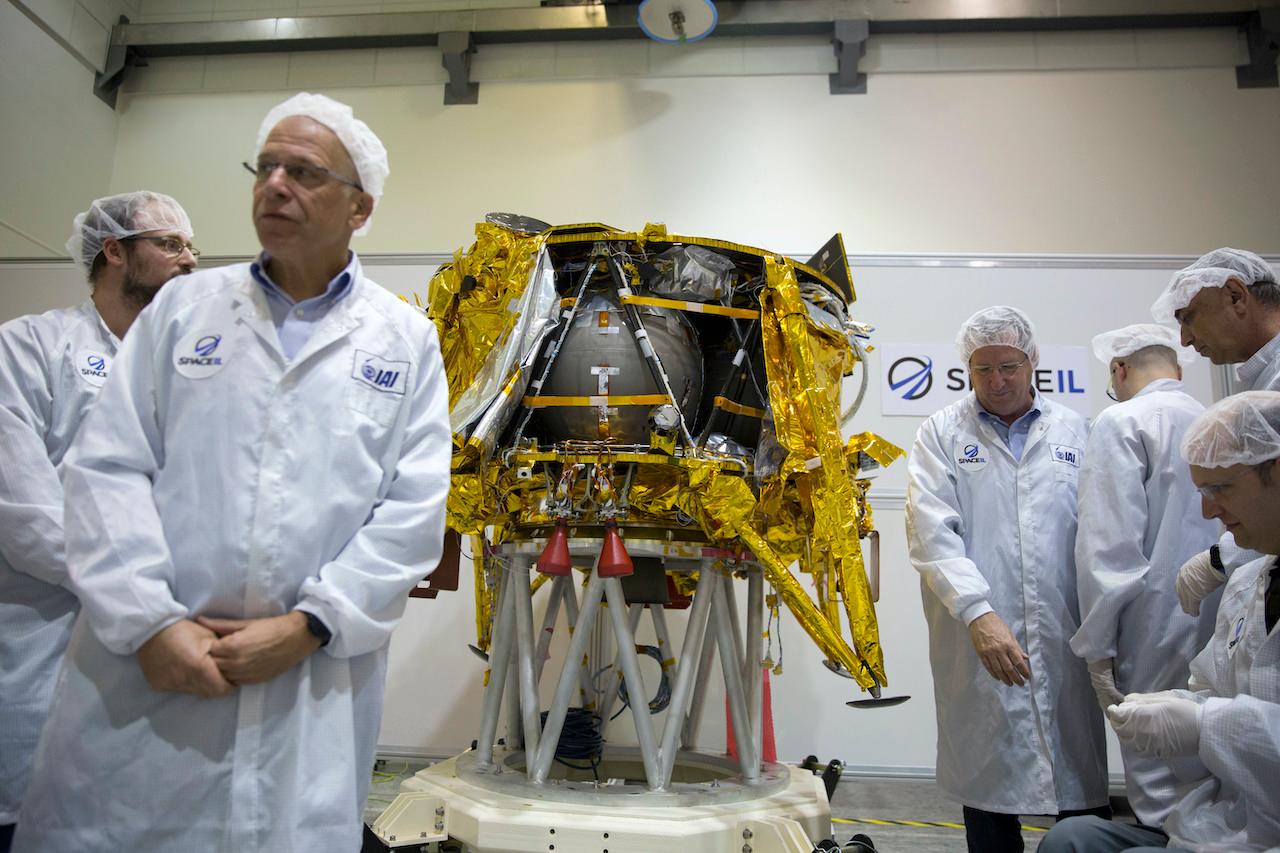 In this Dec 17, 2018 file photo, technicians stand next to the SpaceIL lunar module, an unmanned spacecraft, on display in a special 'clean room' during a press tour of their facility near Tel Aviv, Israel. Photo: AP