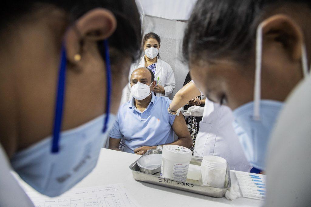 A health worker administers the Covishield vaccine to a man at the Guwahati Medical College hospital in Gauhati, India, March 1. Photo: AP